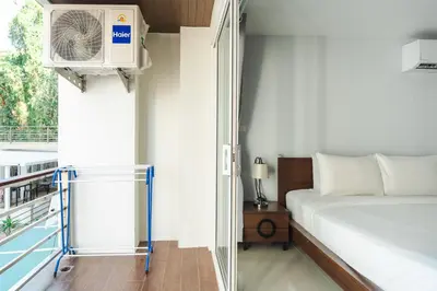 a bedroom with a bed and a air conditioner at Private apartment at Bayshore by Lofty in Patong Beach