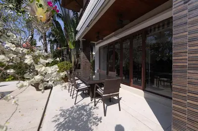 a patio with a table and chairs on a building at Laguna Links Golf View Villa- Bangtao Beach in Phuket Town