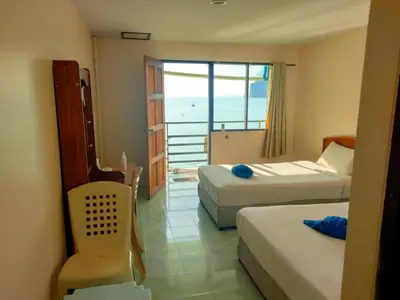 a hotel room with two beds and a view of the ocean at Dalum Beachhouse in Phi Phi Don