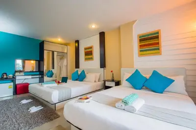 two beds in a room with blue and white at Anchor Boutique House in Patong Beach