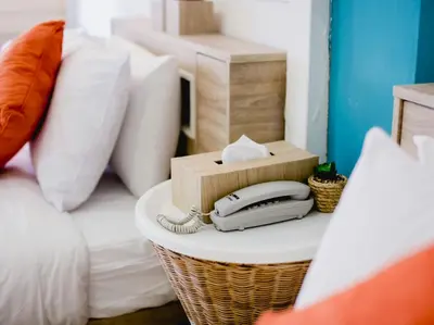 a phone on a table next to a bed at Anchor Boutique House in Patong Beach