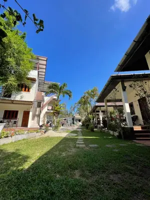 a view of a yard between two buildings at Ron Bungalow in Bang Tao Beach
