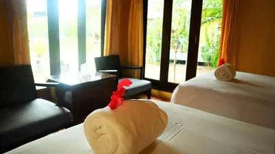 a towel animal sitting on a bed in a hotel room at Koh Yao Noi Beach Resort in Ko Yao Noi