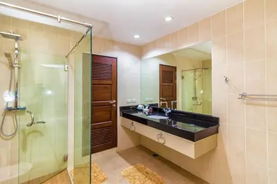 a bathroom with a sink and a glass shower at Karon View Apartments in Karon Beach
