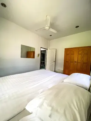 a bedroom with a large white bed and a ceiling at Karon House 15B in Karon Beach
