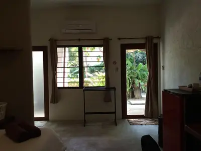 a room with two large windows and a room with a bed at Fern House Retreat in Chalong