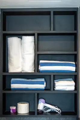 a shelf filled with towels and towels at Suite Celeste 1BR Sunset RooftopCitygate Kamala in Kamala Beach