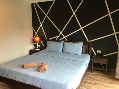 a bedroom with a bed with two towels on it at PP Midnight Hotel in Phi Phi Don