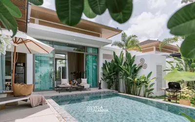 a villa with a swimming pool and a house at Villa Alanna Phuket in Bang Tao Beach