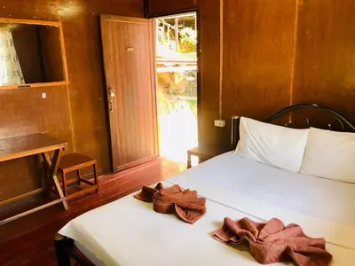 a bedroom with a bed with towels on it at JR GYM & Resort in Phi Phi Don