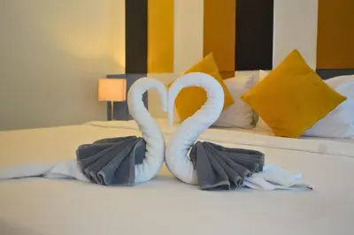two swans made out of towels on a bed at Z&Z Resort in Rawai Beach