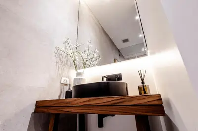 a room with a desk with a chair and a mirror at Mono Oxygen Modern Pool Villas- Bangtao Beach in Phuket Town