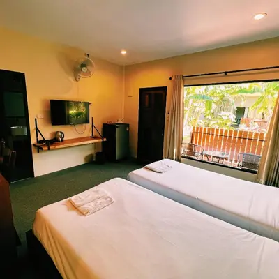 a hotel room with two beds and a window at ViVi Hotel Resort in Phuket Town