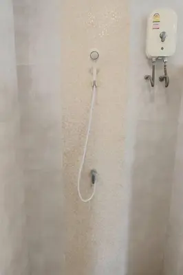 a bathroom with a soap dispenser on a wall at Udomsuk villa phuket in Bang Tao Beach