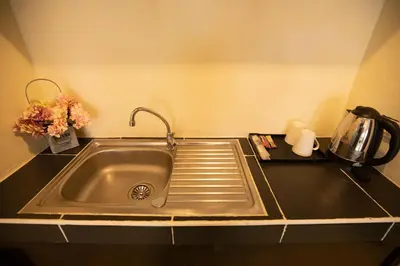 a kitchen counter with a sink and a coffee pot at Lily Holiday hotel \u767e\u5408\u5047\u65e5\u9152\u5e97 in Patong Beach