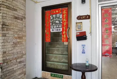 a door with a table in front of a building at Lily Holiday hotel \u767e\u5408\u5047\u65e5\u9152\u5e97 in Patong Beach