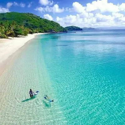 two people on surfboards in the water on a beach at Wonderful Villa in Rawai with Private Pool in Rawai Beach