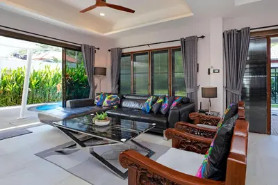 a living room with a couch and a table at Best Holidays - Oxygen pool, Billard, Gym! 2-Storey Tropical Villa Havana N in Kamala Beach