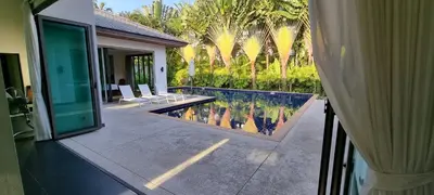 a house with a swimming pool next to a house at Beautiful villa walking distance from Bangtao Beach in Bang Tao Beach