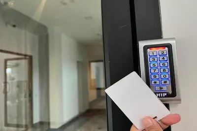 a person holding a remote control in a room at De Piraya residence in Mai Khao Beach
