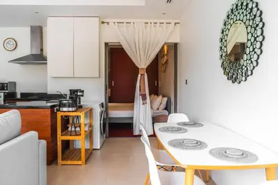 a kitchen and a dining room with a table in a room at The residence resort Villa 1bdr Private Pool in Phuket Town