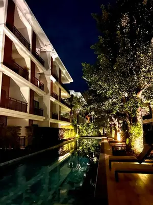 a swimming pool in front of a building at night at The Title Rawai Beachfront (Sea paradise) in Rawai Beach