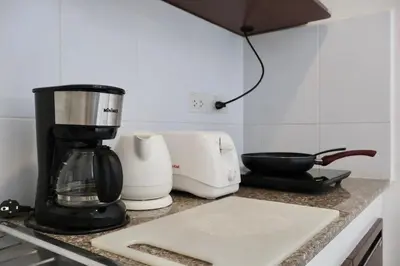 a kitchen counter with a blender and a cutting board at Chonlada Holiday Home - 2 BR Pool Access Bungalow - Kamala Beach in Kamala Beach