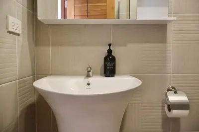 a bathroom with a sink with a bottle on it at Chonlada Holiday Home - 2 BR Pool Access Bungalow - Kamala Beach in Kamala Beach