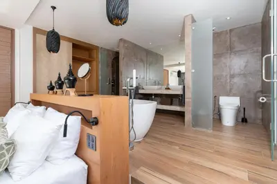 a bathroom with a tub and a toilet and a sink at Eden Escape Naiyang Beach in Phuket Town