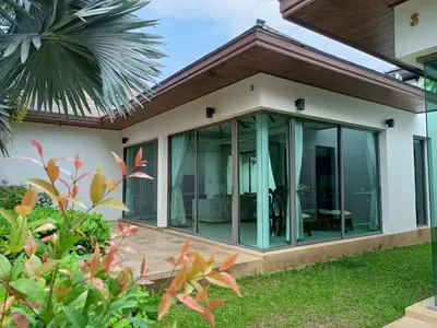 a house with glass doors and a patio at Poly Villa Naya 3 in Rawai Beach