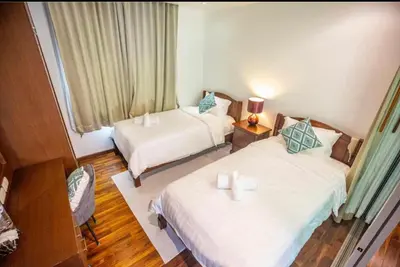 a room with two beds in a hotel room at Poly Villa Naya 3 in Rawai Beach