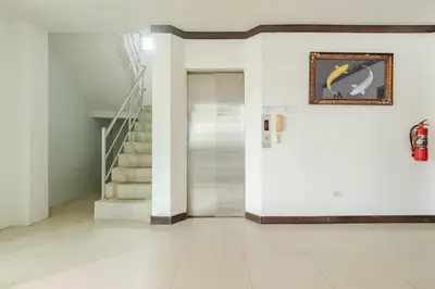 a hallway with a door and a painting on the wall at Goodday Kathu in Kathu