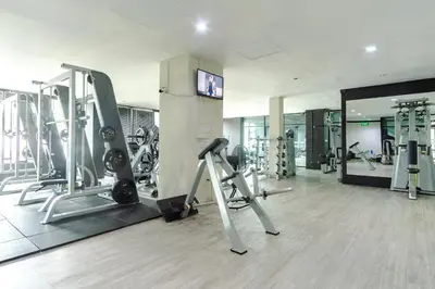 a gym with treadmills and machines in a room at Goodday Kathu in Kathu