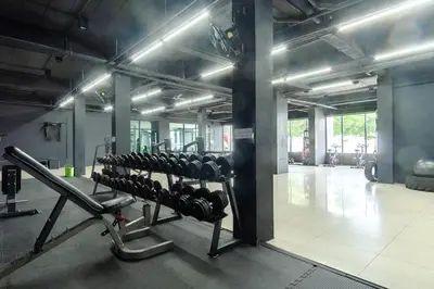 a gym with a row of dumbbells at Goodday Kathu in Kathu