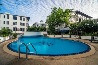 a large blue swimming pool in front of some buildings at Patong Tower apartment by Lofty in Patong Beach
