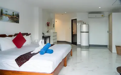 a bedroom with a bed with a blue pillow on it at Deng's kamala beach Guesthouse in Kamala Beach