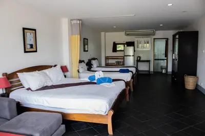 a hotel room with four beds and a couch at Deng's kamala beach Guesthouse in Kamala Beach