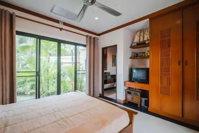 a bedroom with a large bed and a television at Lotus Pool Villa Your Own Slice Of Island Paradise in Rawai Beach