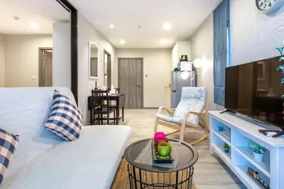 a living room with a bed and a table in a room at Title НайЯнг NaiYang in Nai Yang Beach