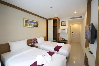 a hotel room with two beds with bows on them at The Patong Center Hotel in Patong Beach