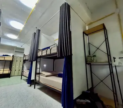 a room with three bunk beds in a room at Sweed Dee Hostel in Phi Phi Don