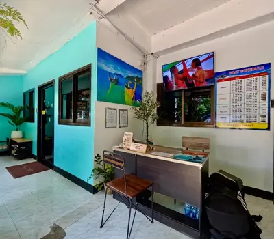 an office with a desk and a sign on the wall at Sweed Dee Hostel in Phi Phi Don