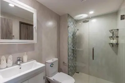 a bathroom with a shower and a toilet and a sink at Title Naiyang residence Excellent location with pool view in Nai Yang Beach