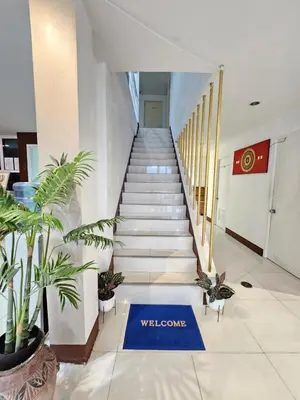 a staircase in a building with a welcome sign on the floor at La Xenia Hotel Kata Beach in Kata Beach