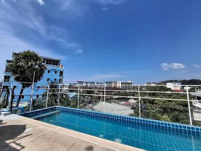 a swimming pool on the side of a building at La Xenia Hotel Kata Beach in Kata Beach