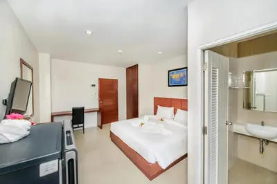 a hotel room with a bed and a sink at The Topaz Residence Phuket Town in Phuket Town