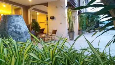 a room with plants and a large pot at Green House Phuket in Ban Pa Khlok