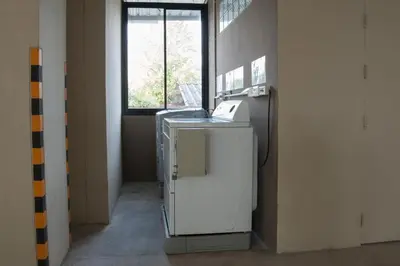 an empty room with a machine in front of a window at Naka Residence in Phuket Town
