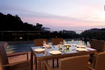 a table with wine glasses on top of a balcony at Phuket Kamala, Spectacular Seaviews, Private pool, 3 BR in Kamala Beach