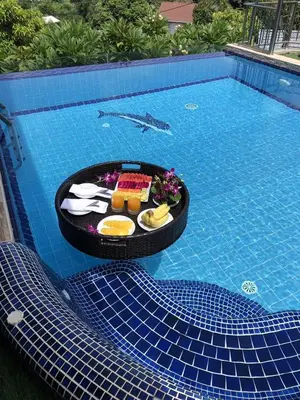 a tray of food in a swimming pool at Luxury Four Bed Villa Jasmine, infinity pool, full staff , chef and breakfasts in Kata Beach